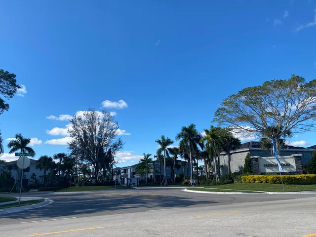 a large kitchen with stainless steel appliances kitchen island a large counter top and a floors