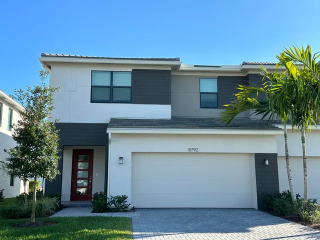 a kitchen with refrigerator cabinets and wooden floor