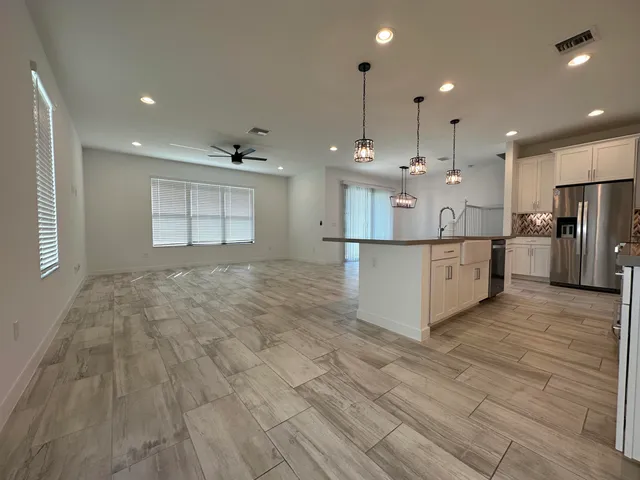 a view of a hallway with wooden floor and cabinet