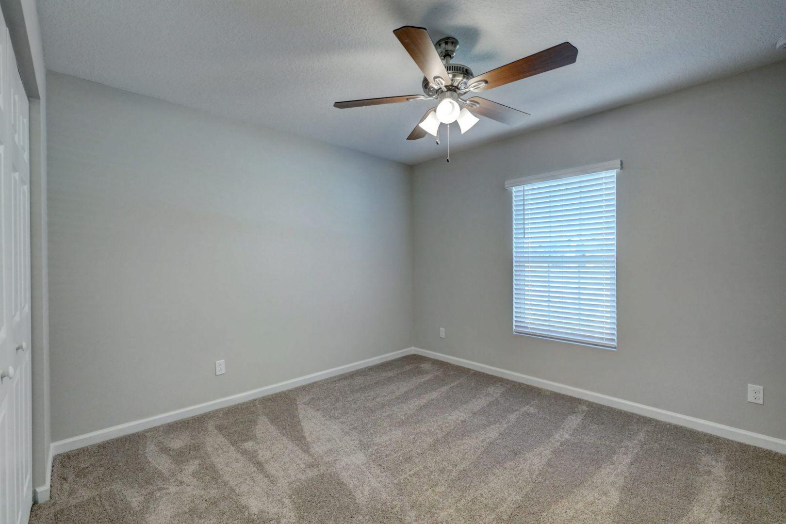 444 Southwest Log Drive Port St. Lucie, FL 34953 - Photo 30 of 54 an empty room with a window and a fan