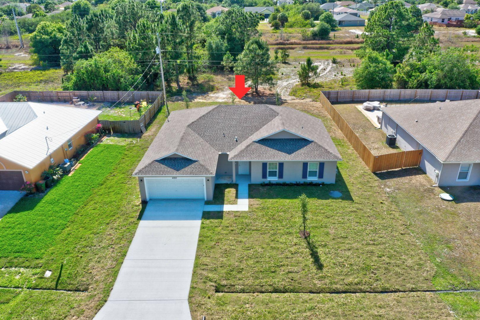 444 Southwest Log Drive Port St. Lucie, FL 34953 - Photo 45 of 54 a aerial view of a house with swimming pool