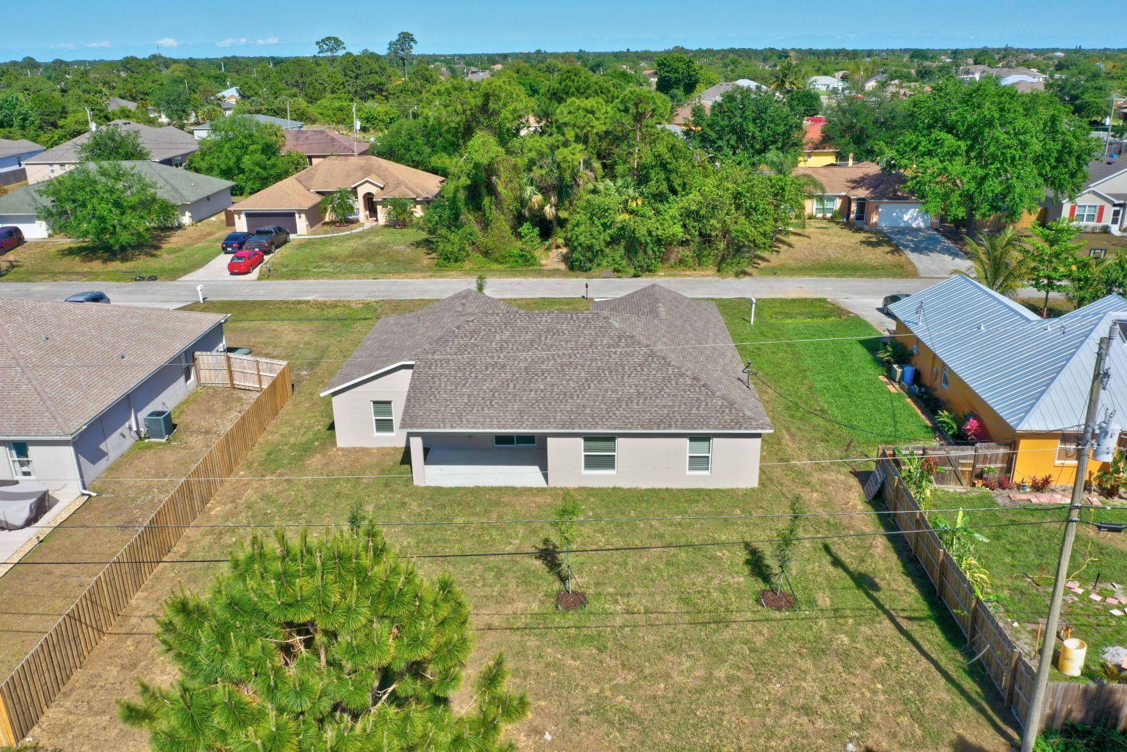 444 Southwest Log Drive Port St. Lucie, FL 34953 - Photo 49 of 54 an aerial view of a house with a garden