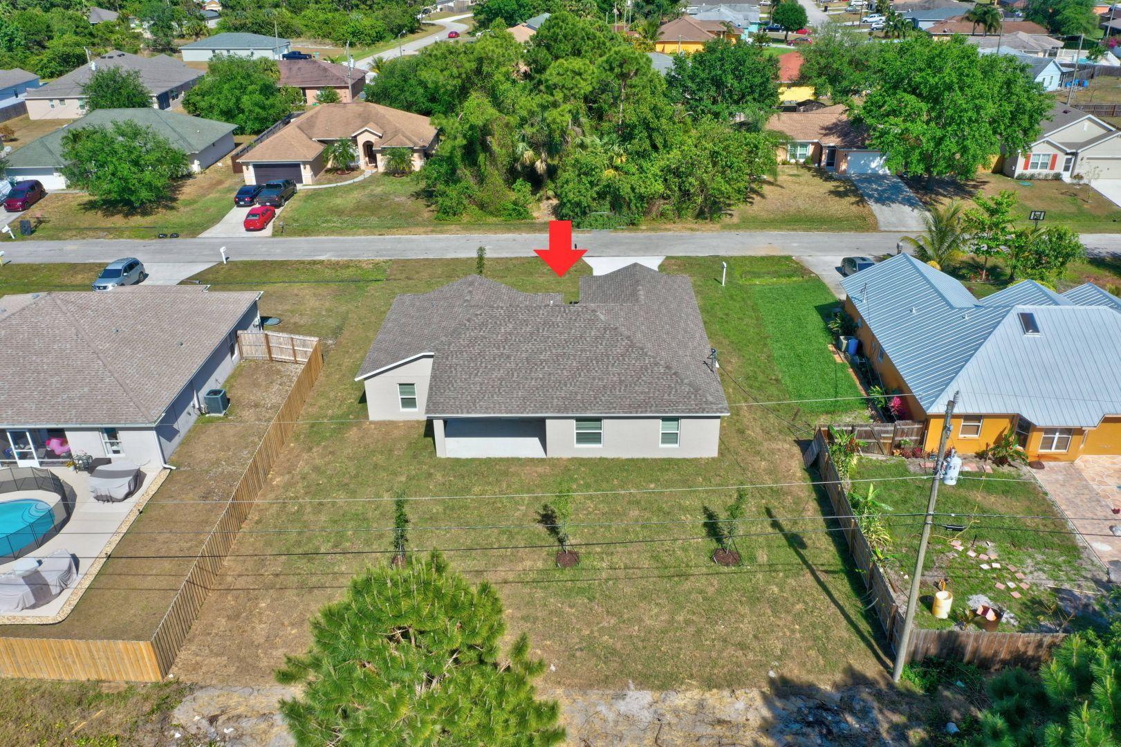 444 Southwest Log Drive Port St. Lucie, FL 34953 - Photo 50 of 54 an aerial view of a house with swimming pool garden and patio