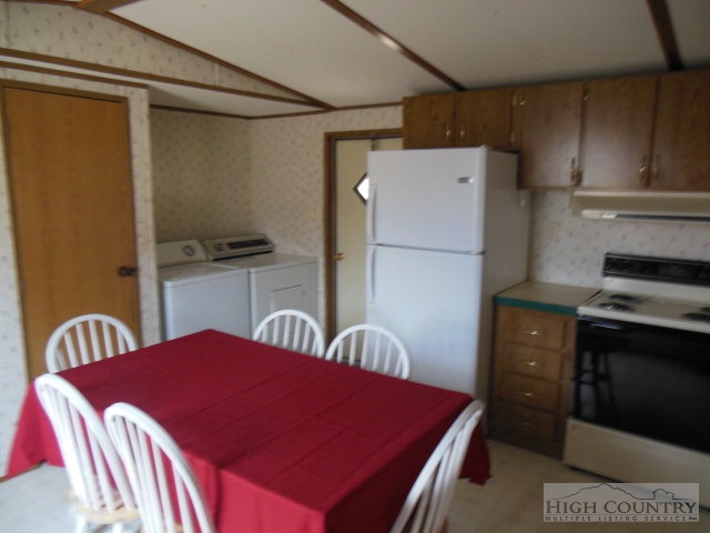 522 Quincy Road Sparta, NC 28675 - Photo 17 of 20 a kitchen with a refrigerator and a stove top oven