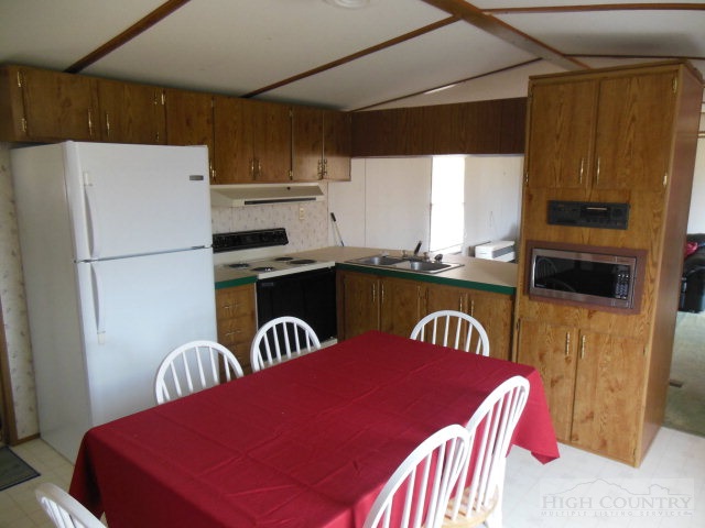 522 Quincy Road Sparta, NC 28675 - Photo 20 of 20 a kitchen with a sink a refrigerator and a table
