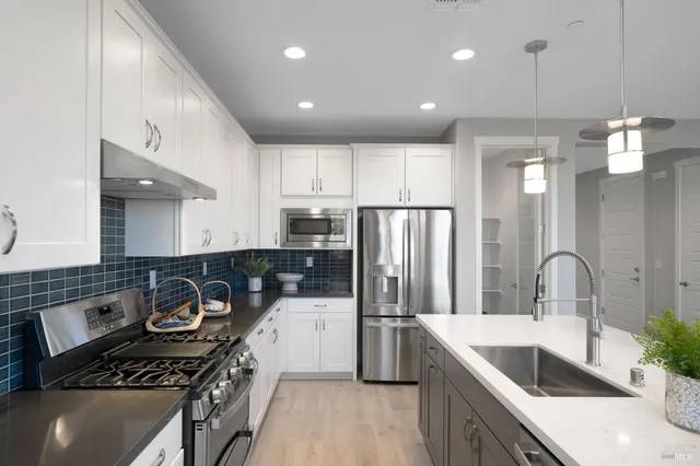 a kitchen with a white cabinets and stove