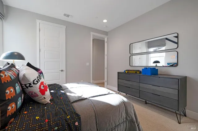 a bed room with a bed and a painting on the wall