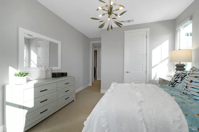 a bedroom with a bed and a dresser