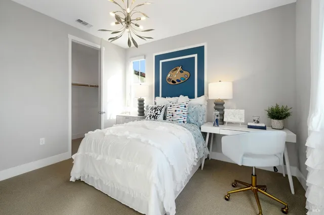 a bedroom with a bed and a dresser