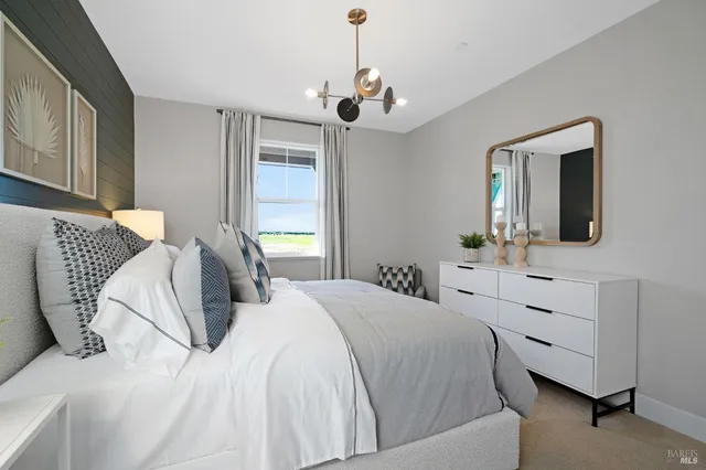 a bedroom with a bed dresser and a window