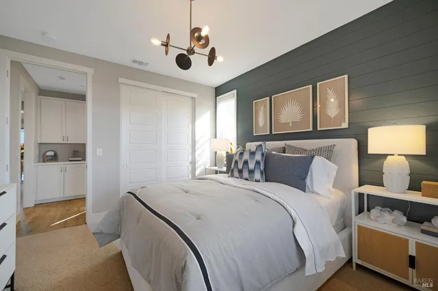 a bedroom with a bed and a chandelier