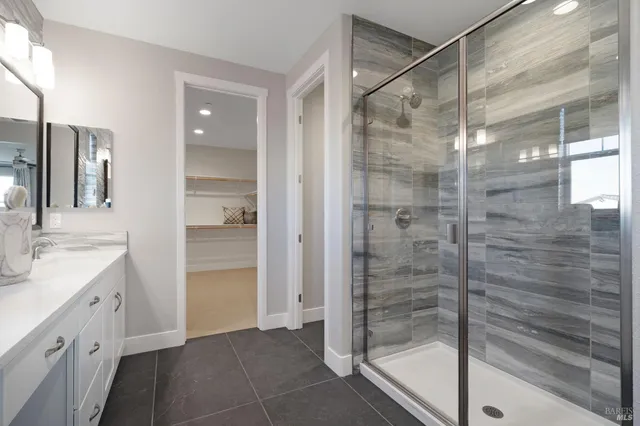 a spacious bedroom with a bed and a chandelier