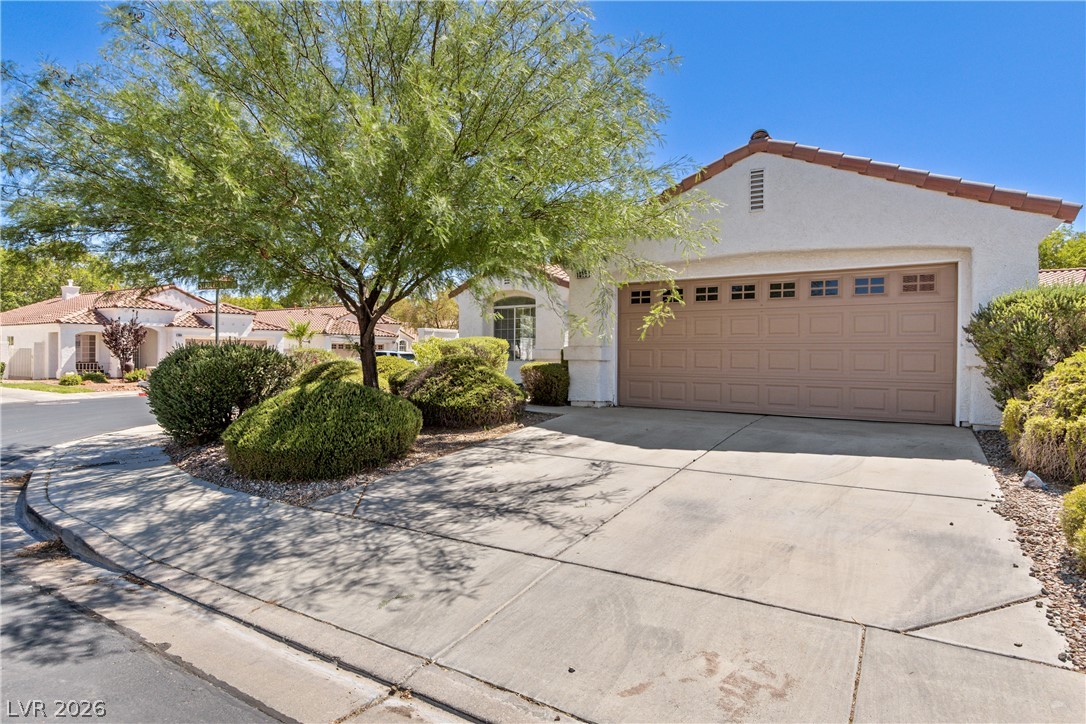 1815 Stablegate Avenue Henderson, NV 89012 - Photo 1 of 28 A classic tiled roofline crowns this home, offering a pristine driveway and integrated garage.