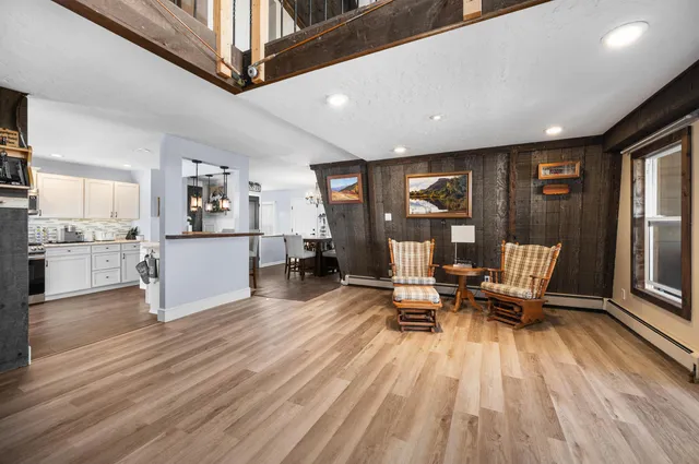 a living room with furniture and a floor to ceiling window