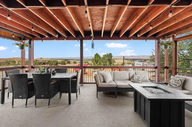 a kitchen with stainless steel appliances kitchen island granite countertop a refrigerator a stove and white cabinets with wooden floor