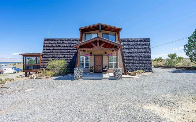 a front view of a house with yard and porch