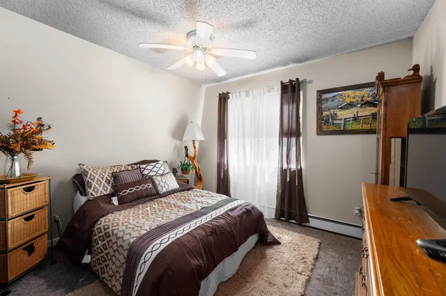a bedroom with a bed and a chandelier