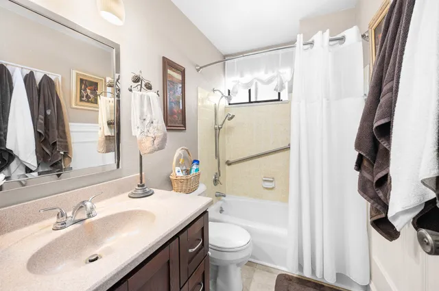 a bathroom with a sink toilet and shower