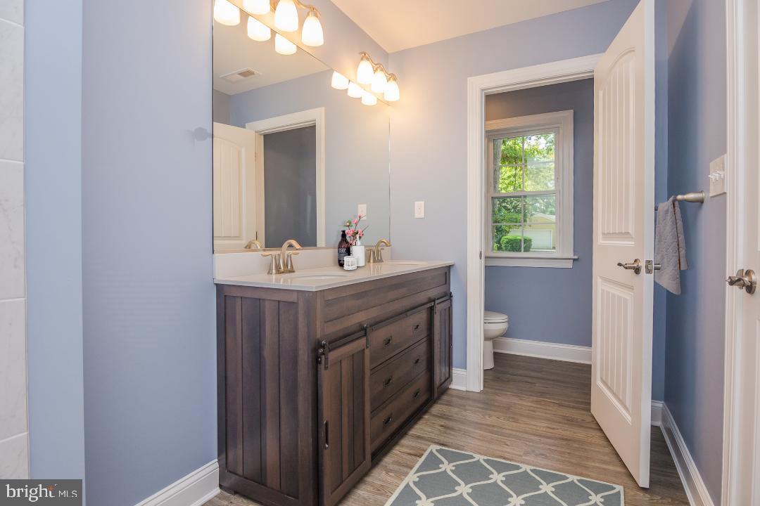 153 Fooks Road Bishopville, MD 21813 - Photo 25 of 30 a bathroom with a double vanity sink mirror and toilet