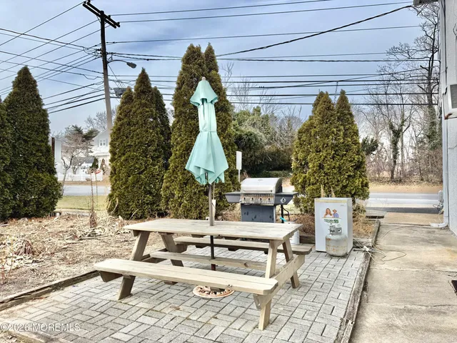 a view of roof deck with couch and chairs