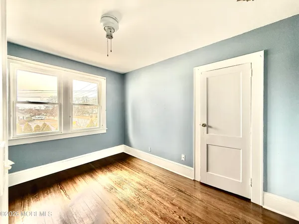 a view of room with window and hardwood floor