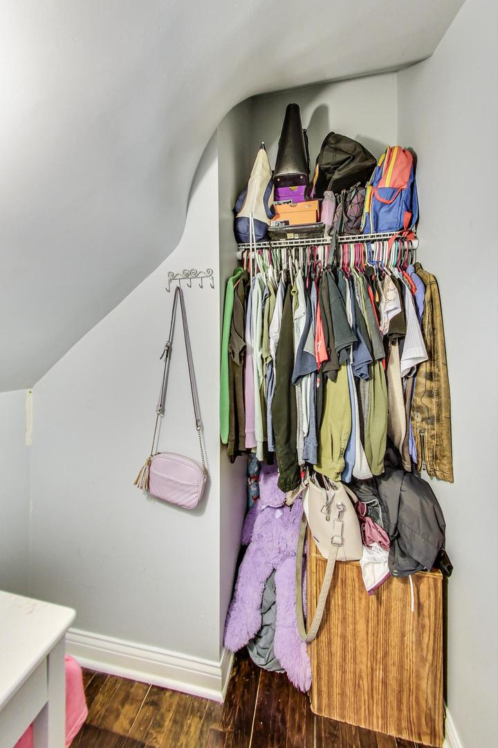 4237 West School Street Chicago, IL 60641 - Photo 17 of 72 a view of walk in closet with clothes and shoes