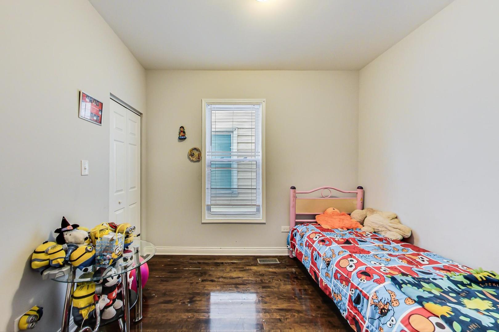 4237 West School Street Chicago, IL 60641 - Photo 18 of 72 a bedroom with a bed and a window