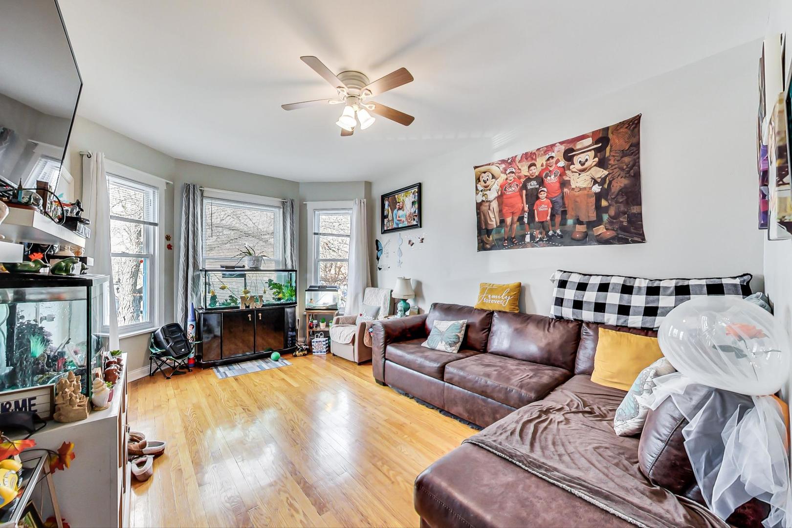 4237 West School Street Chicago, IL 60641 - Photo 23 of 72 a living room with furniture and a flat screen tv