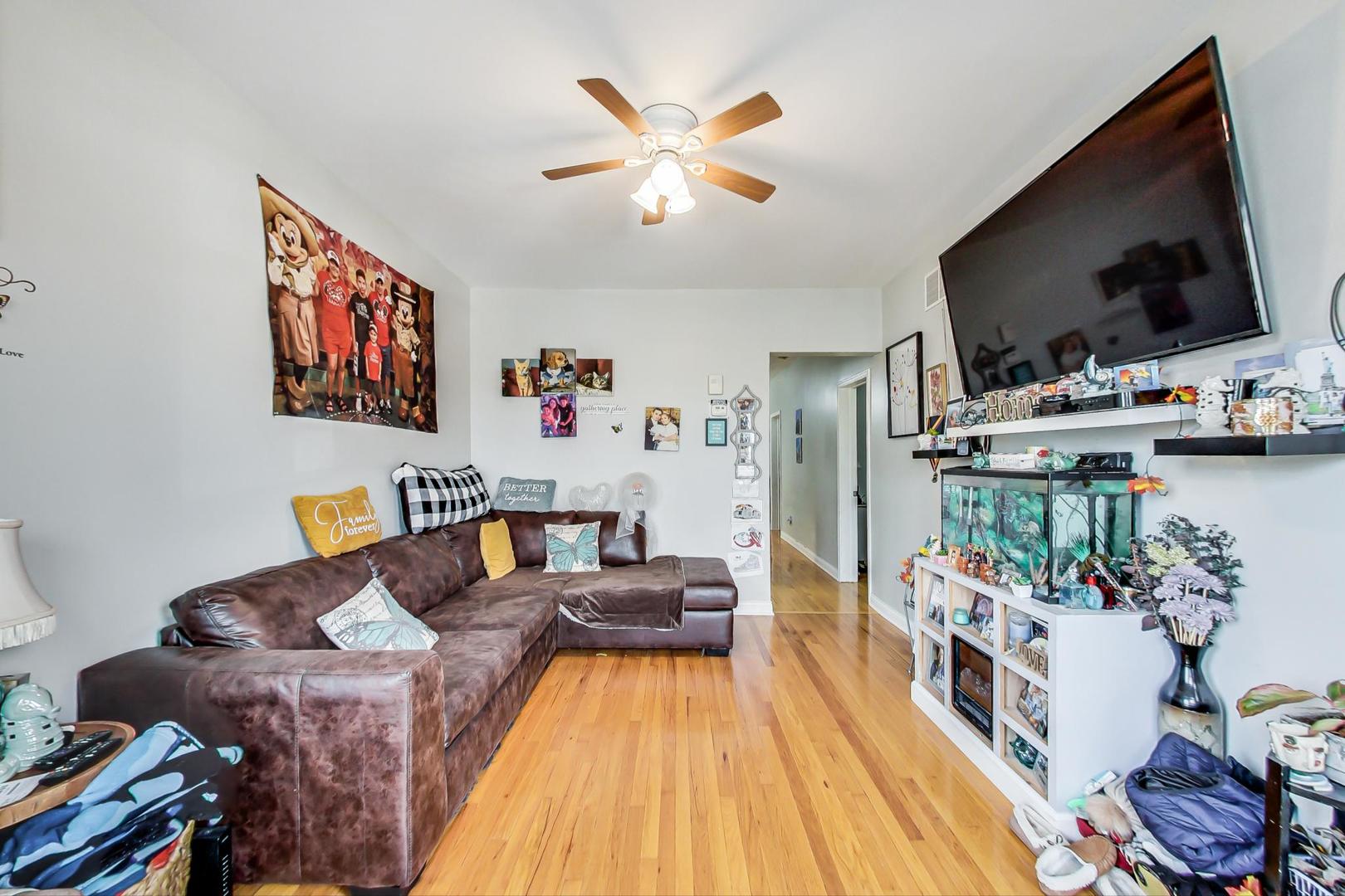 4237 West School Street Chicago, IL 60641 - Photo 24 of 72 a living room with furniture and flat screen tv