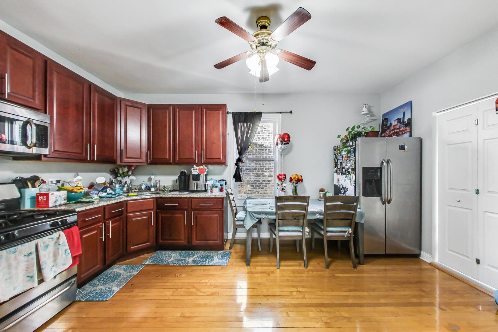 4237 West School Street Chicago, IL 60641 - Photo 28 of 72 a kitchen with stainless steel appliances granite countertop a refrigerator and a stove top oven