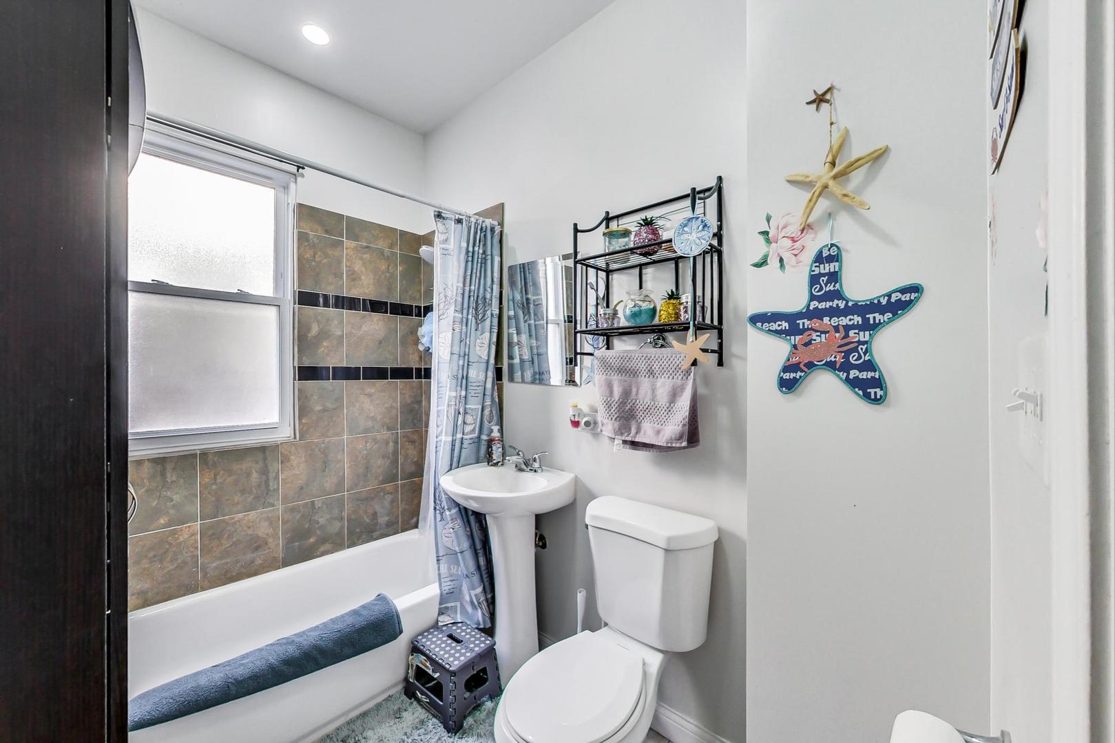 4237 West School Street Chicago, IL 60641 - Photo 29 of 72 a bathroom with a sink toilet and shower