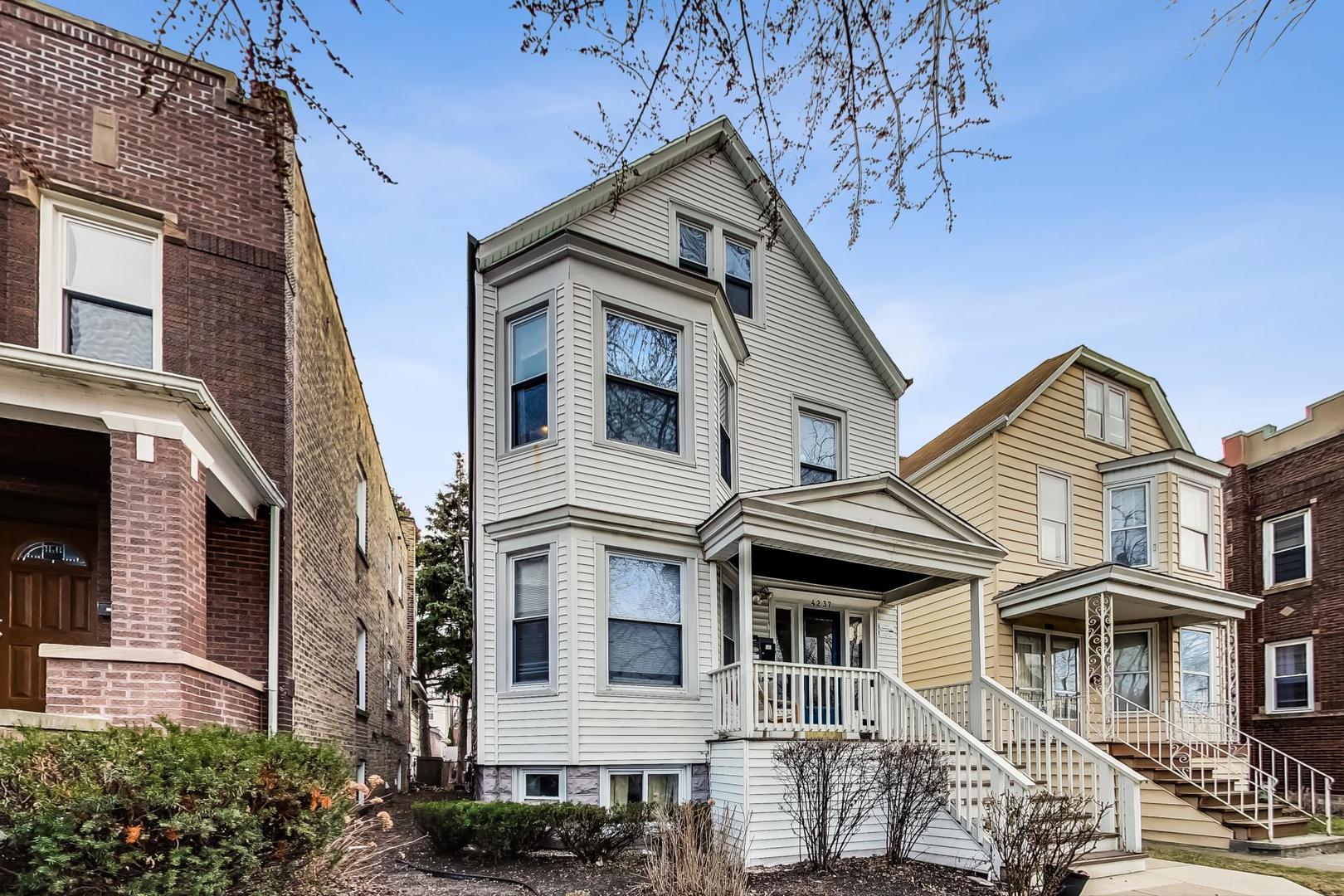 4237 West School Street Chicago, IL 60641 - Photo 3 of 72 a view of a white house with large windows