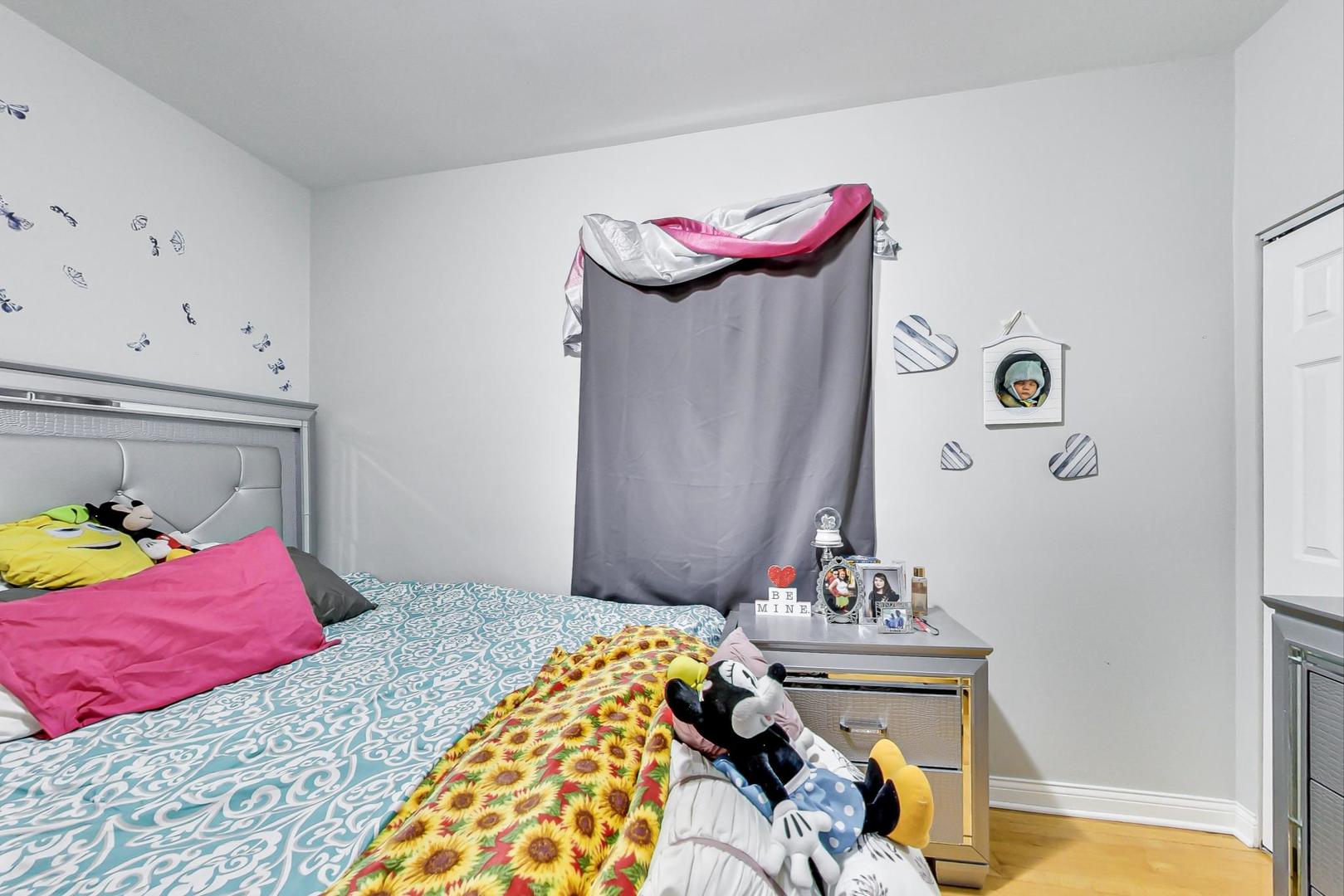 4237 West School Street Chicago, IL 60641 - Photo 32 of 72 a bedroom with a bed and a dresser