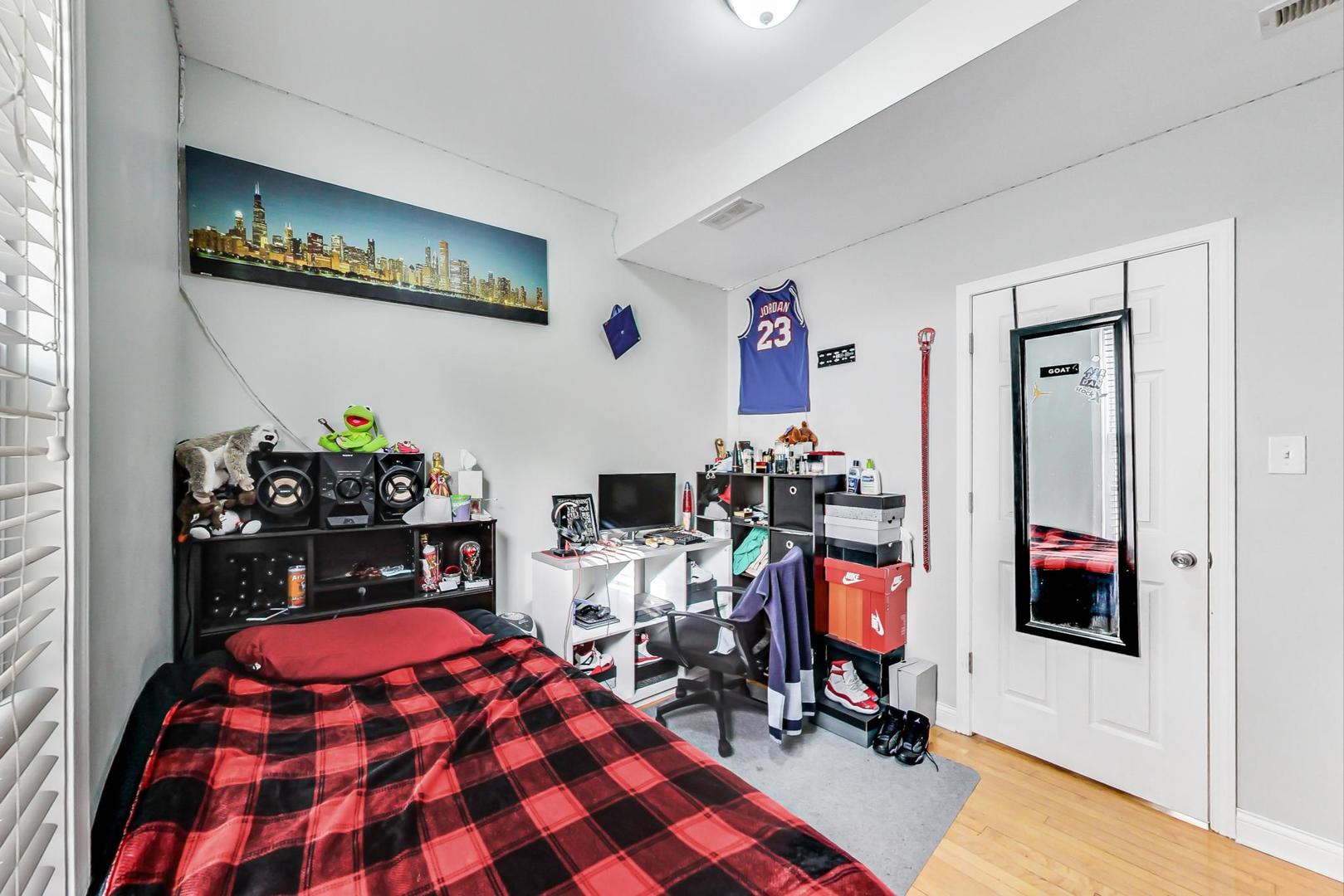 4237 West School Street Chicago, IL 60641 - Photo 33 of 72 a bedroom with a bed and gym equipment