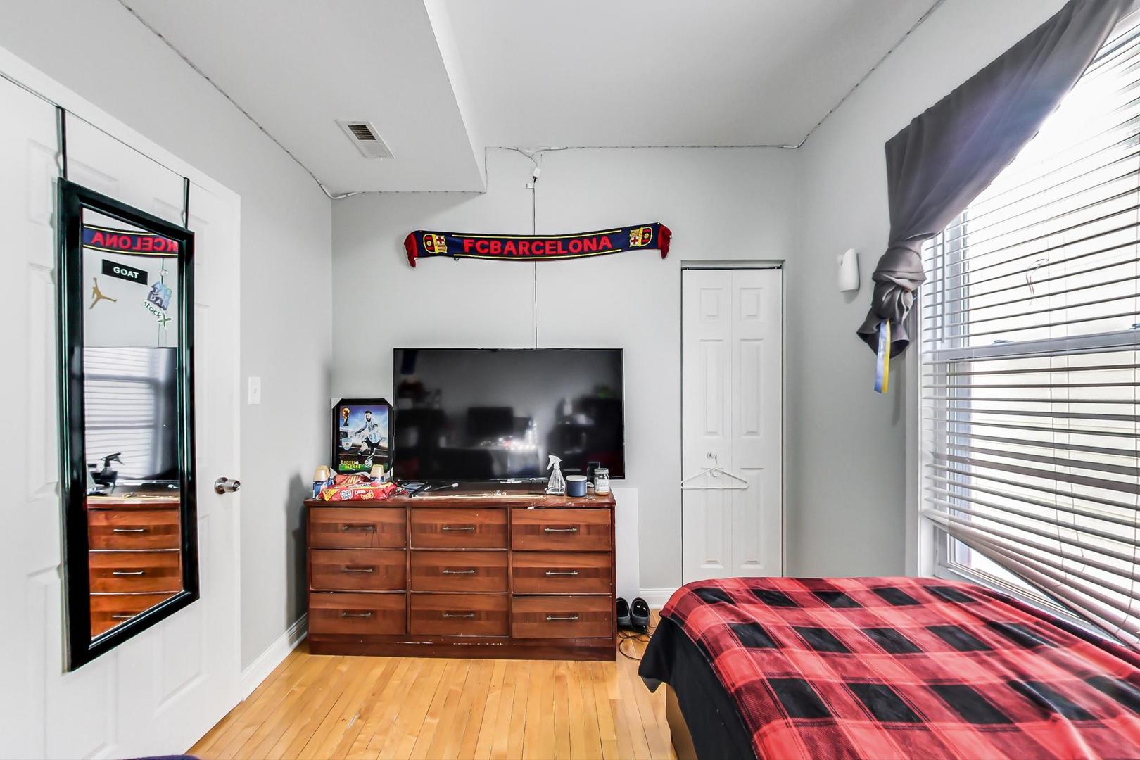 4237 West School Street Chicago, IL 60641 - Photo 34 of 72 a room with a bed and a flat screen tv