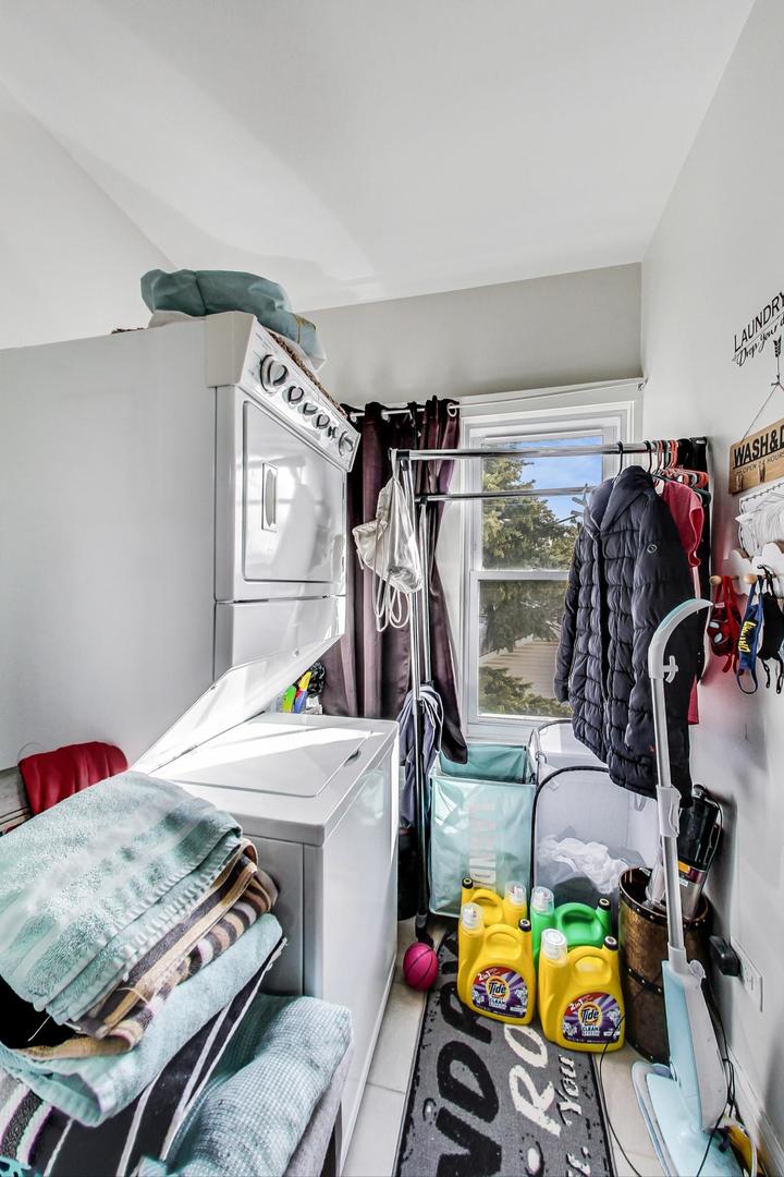 4237 West School Street Chicago, IL 60641 - Photo 36 of 72 a view of walk in closet with clothes and shoes