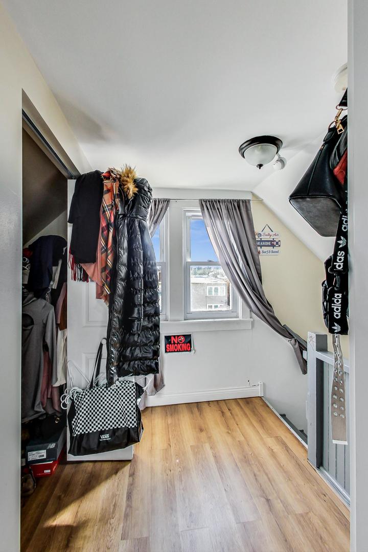 4237 West School Street Chicago, IL 60641 - Photo 37 of 72 a view of walk in closet with clothes and shoes