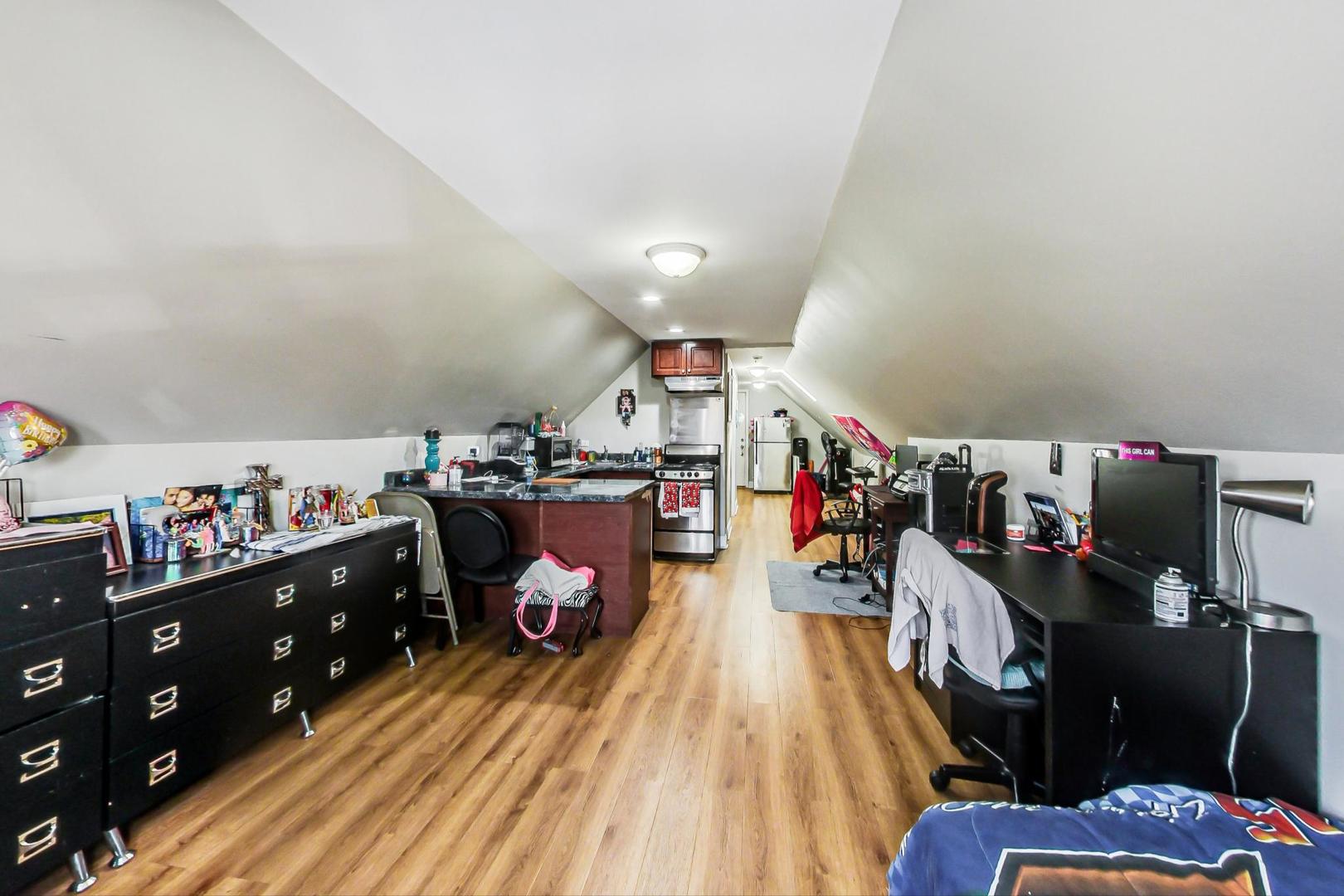4237 West School Street Chicago, IL 60641 - Photo 40 of 72 a living room with lots of furniture and clutter