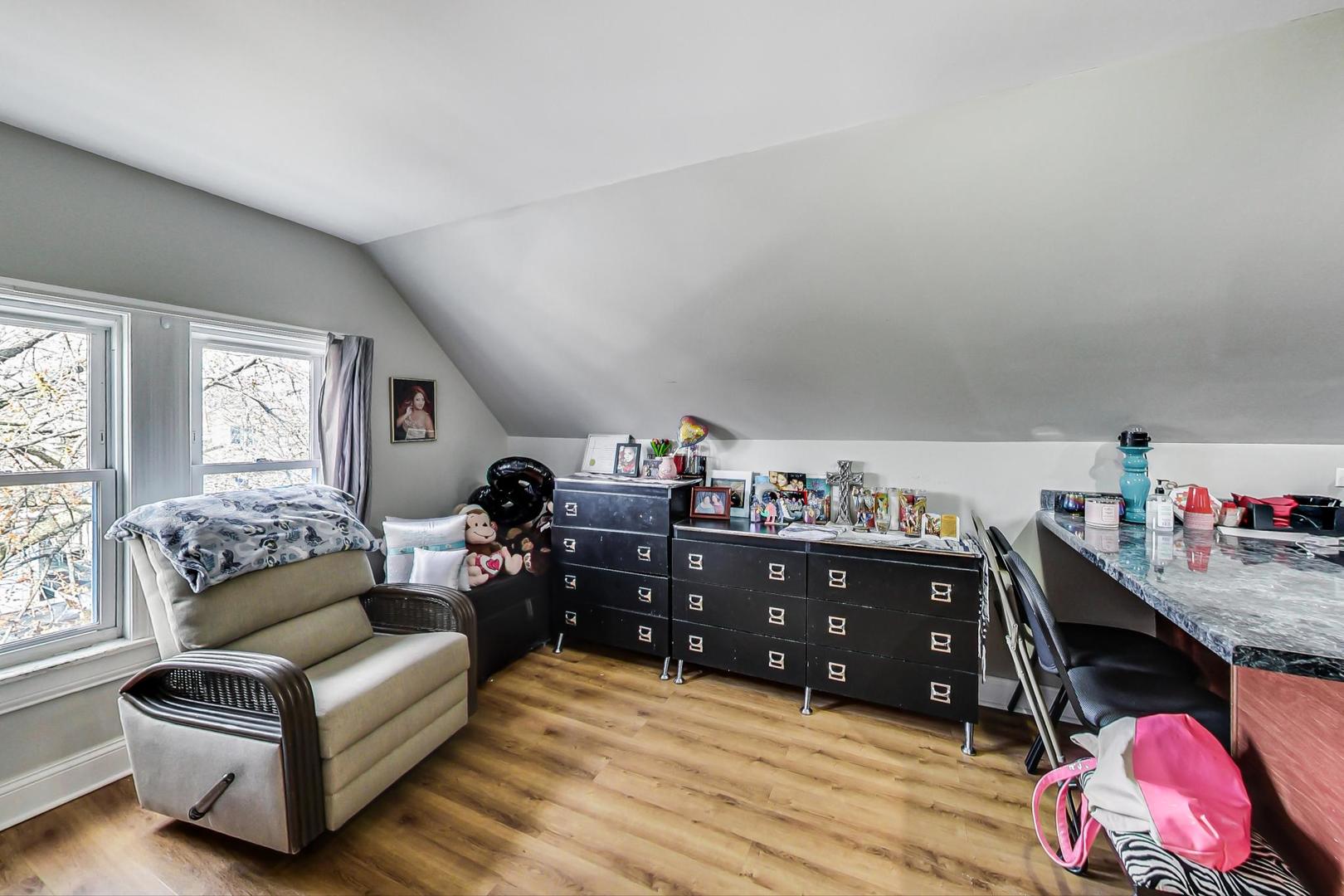 4237 West School Street Chicago, IL 60641 - Photo 43 of 72 a living room with furniture and a wooden floor