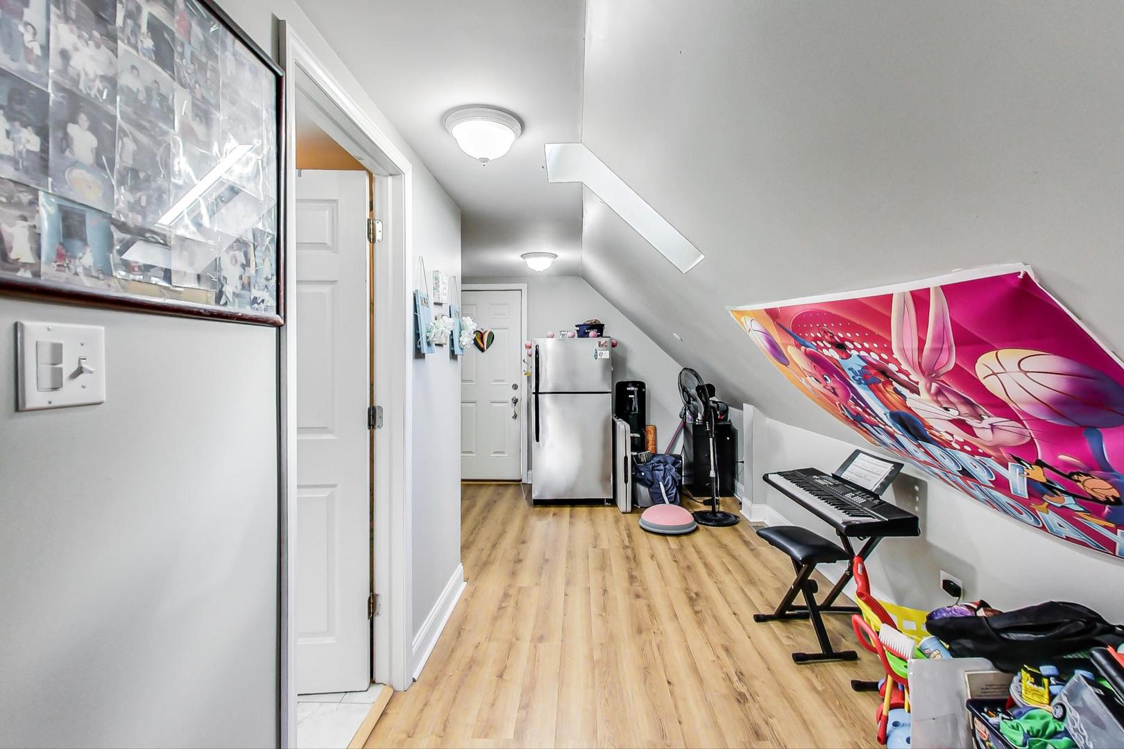 4237 West School Street Chicago, IL 60641 - Photo 48 of 72 a view of a hallway with wooden floor and stairs