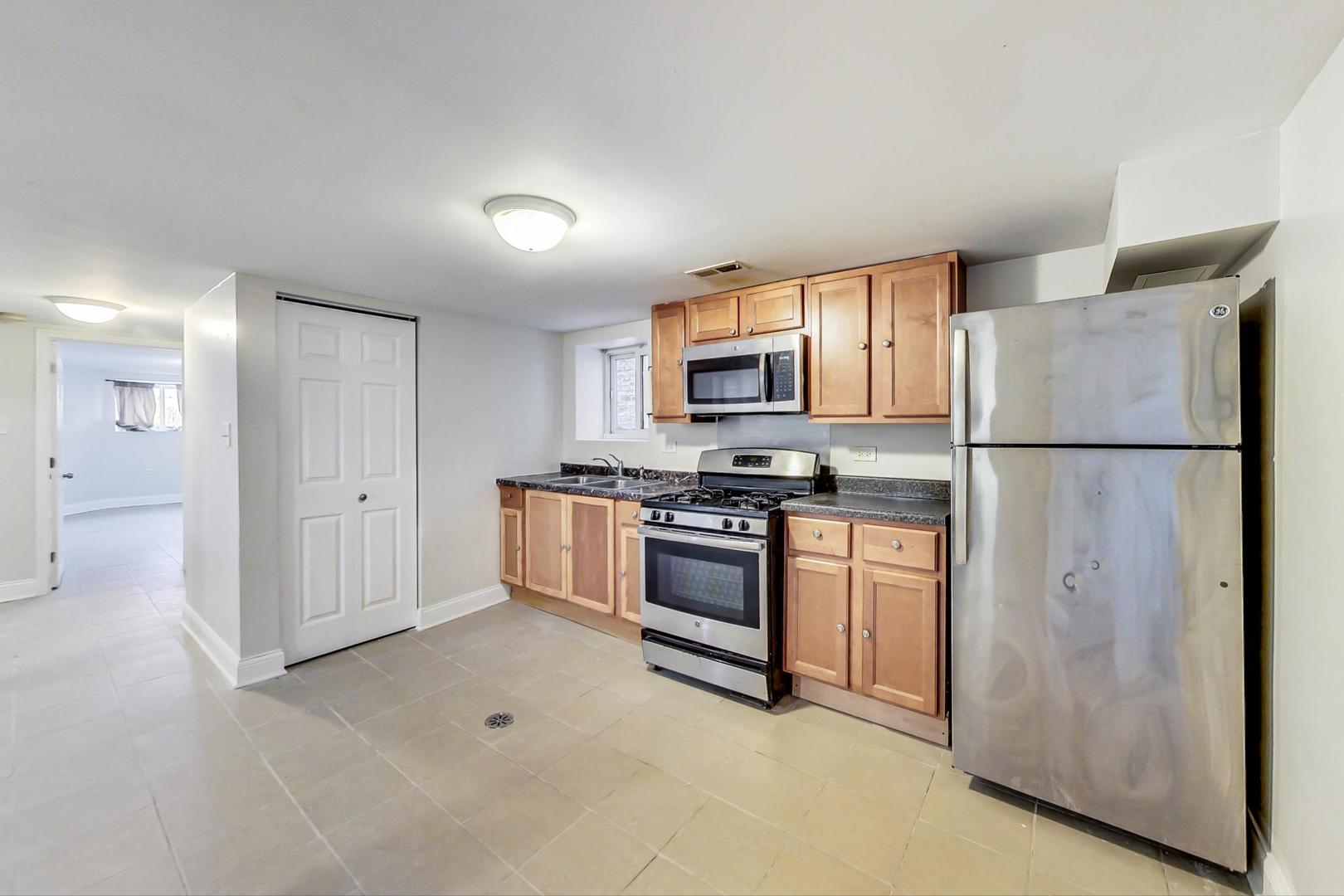 4237 West School Street Chicago, IL 60641 - Photo 54 of 72 a kitchen with stainless steel appliances granite countertop a refrigerator a stove a sink and a microwave