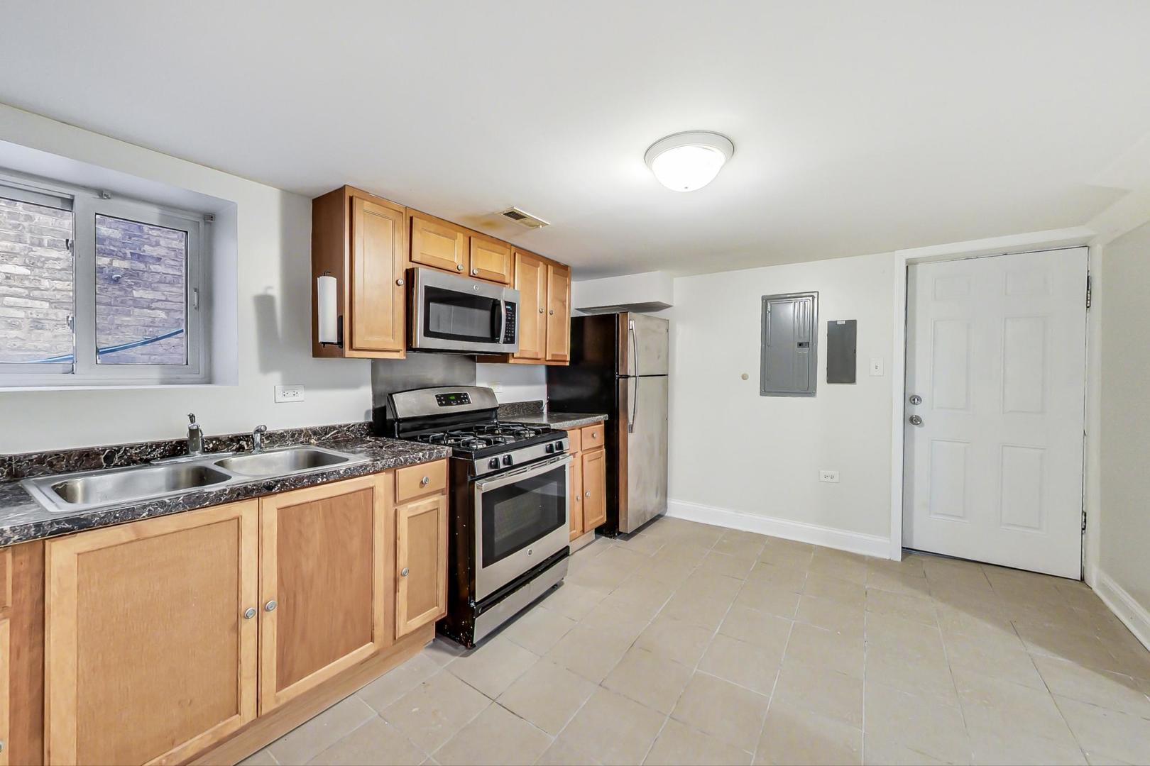 4237 West School Street Chicago, IL 60641 - Photo 55 of 72 a kitchen with stainless steel appliances granite countertop a stove a sink and a refrigerator
