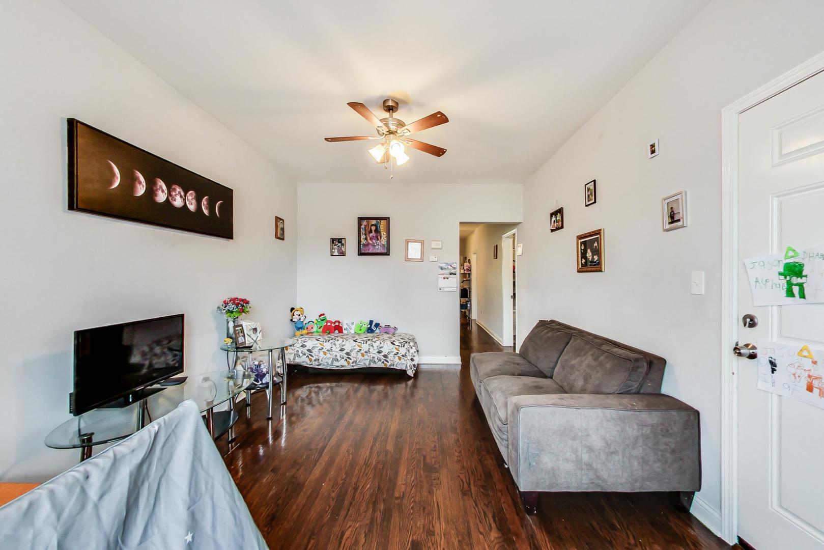 4237 West School Street Chicago, IL 60641 - Photo 7 of 72 a living room with furniture and a flat screen tv