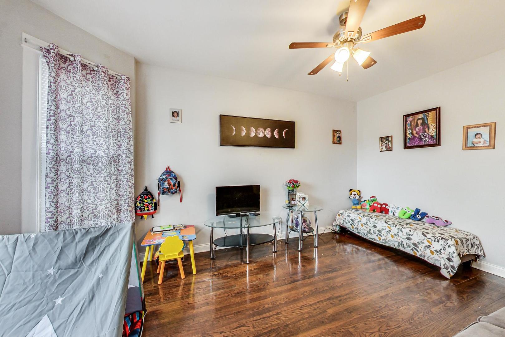 4237 West School Street Chicago, IL 60641 - Photo 9 of 72 a living room with furniture and a flat screen tv