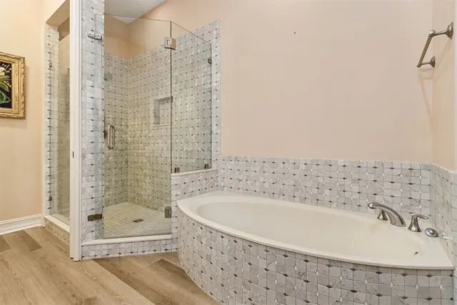 a view of a hallway with wooden floor and dining space