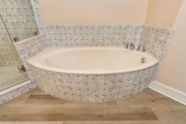 a large bed sitting in a bedroom next to a window