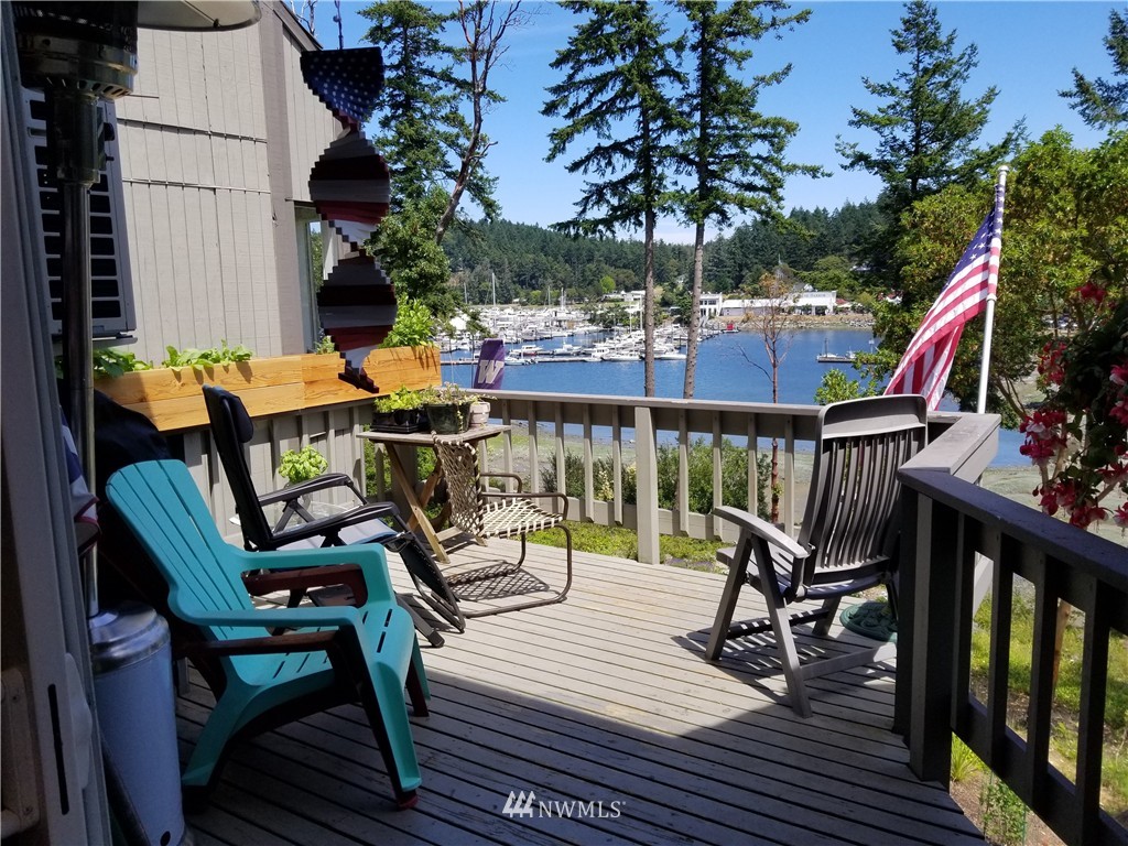 98 Armadale Road, Unit 211 San Juan Island, WA 98250 - Photo 1 of 15 a view of a chairs and table in patio with wooden floor