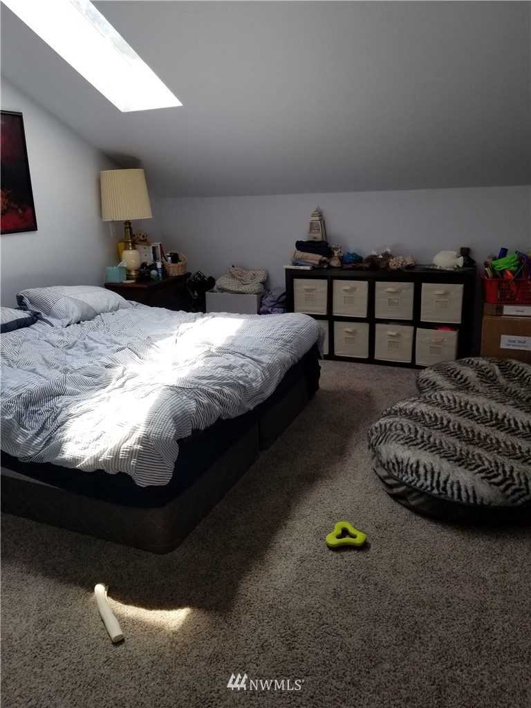 98 Armadale Road, Unit 211 San Juan Island, WA 98250 - Photo 13 of 15 a bed sitting in a bedroom next to a lamp