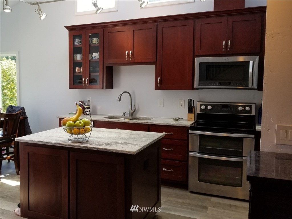 98 Armadale Road, Unit 211 San Juan Island, WA 98250 - Photo 6 of 15 a kitchen with a sink stove and microwave