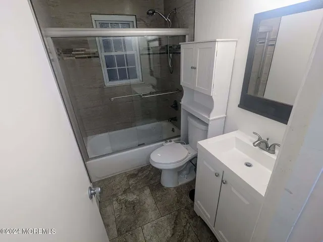 a bathroom with a sink a light fixture and a mirror